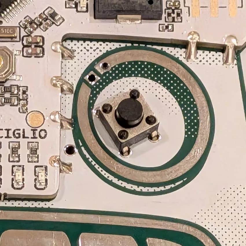 Button placed over SauceBot's left eye, aligned with the four holes