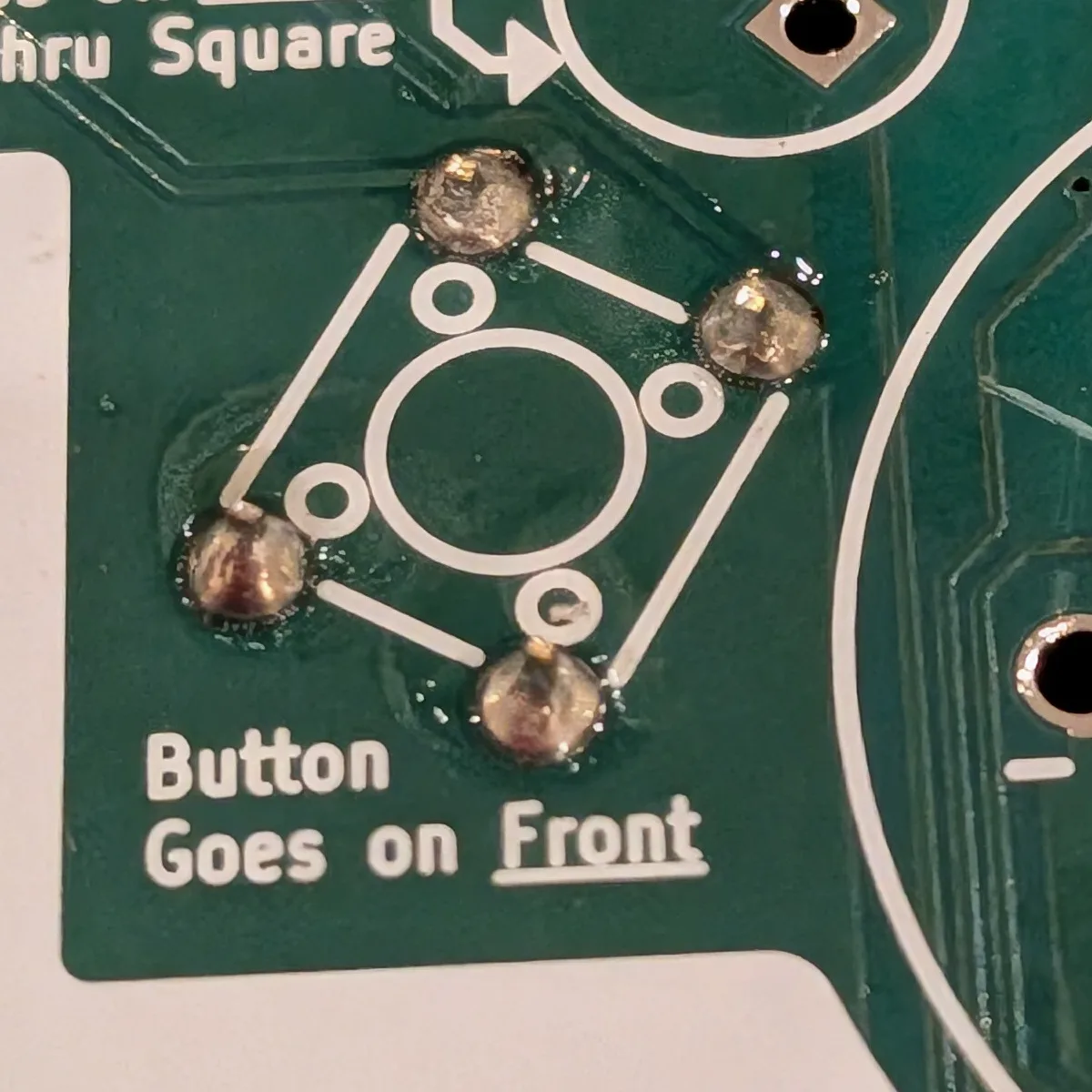 All four button leads soldered on the back of the badge