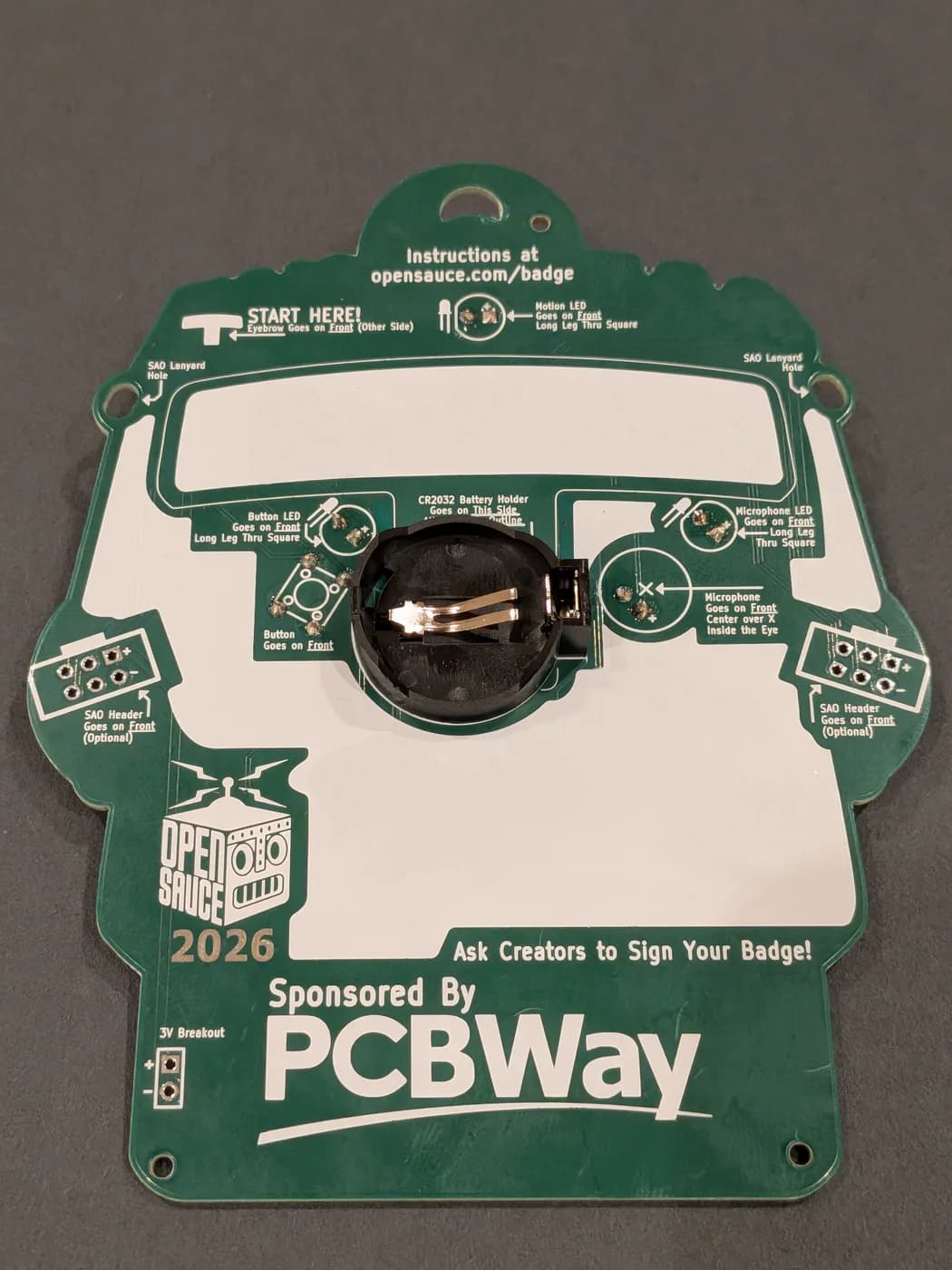 Battery holder placed in its outline on the back of the badge