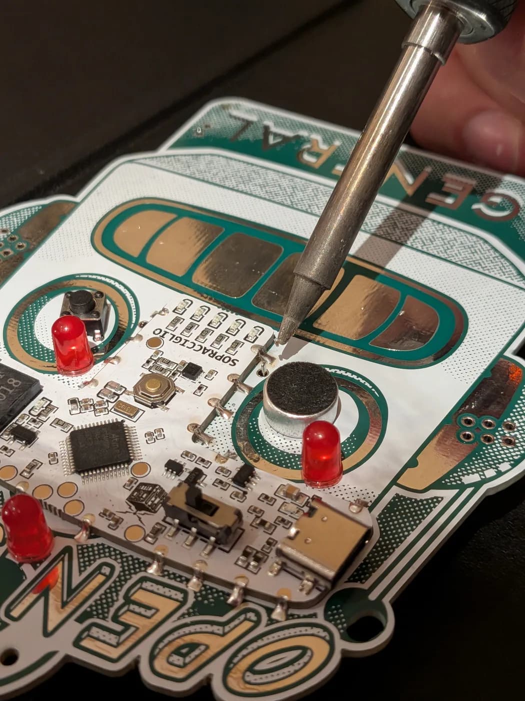 Soldering the battery holder from the front, iron held clear of the finished parts