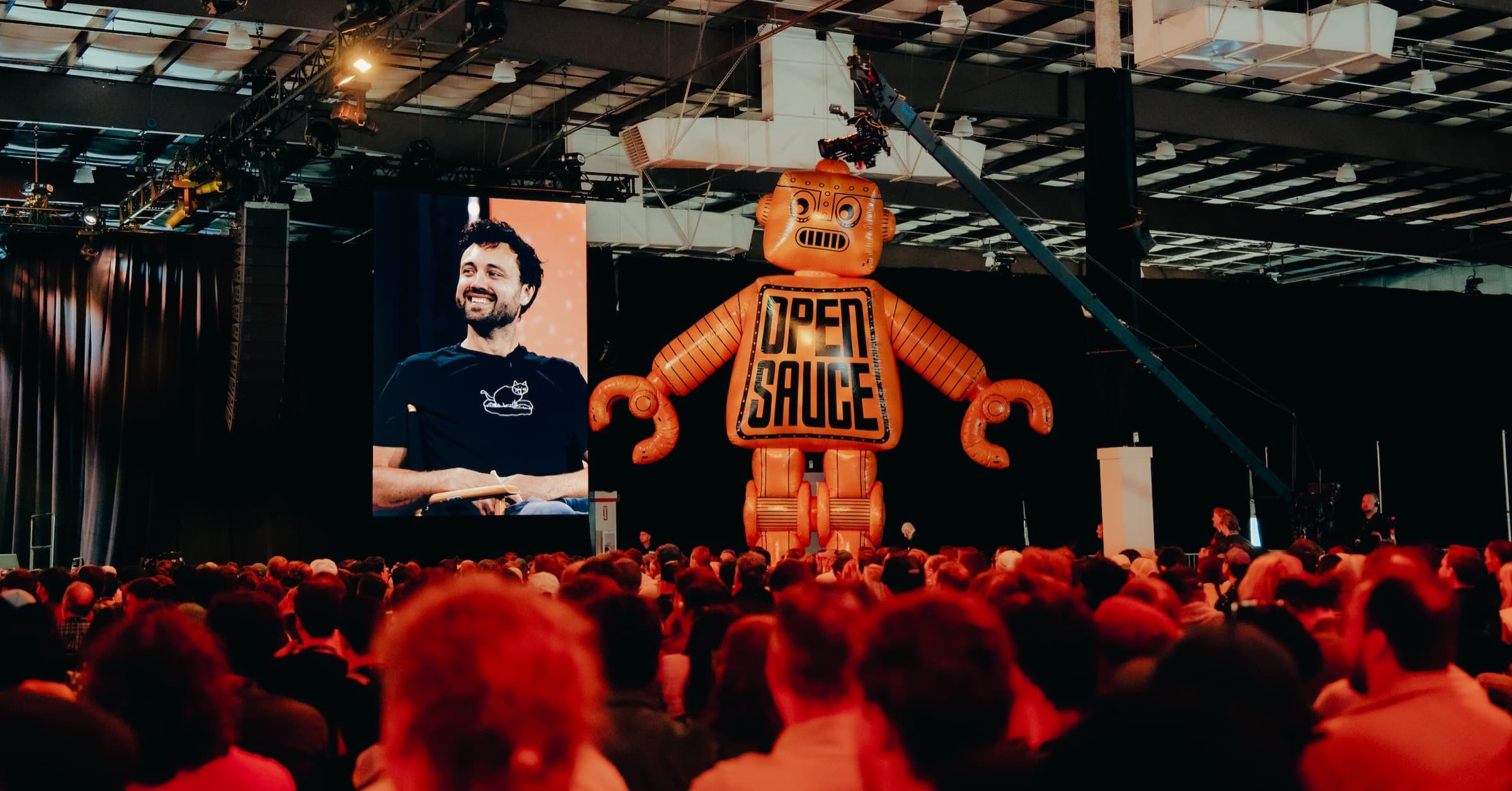 Giant inflatable Open Sauce robot towering over the main stage crowd